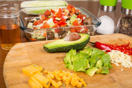 salad vegetables and ingredients sliced on a cutting boardの写真素材