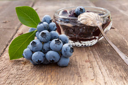 blueberry jam and berries close-up on an old wooden tableの写真素材