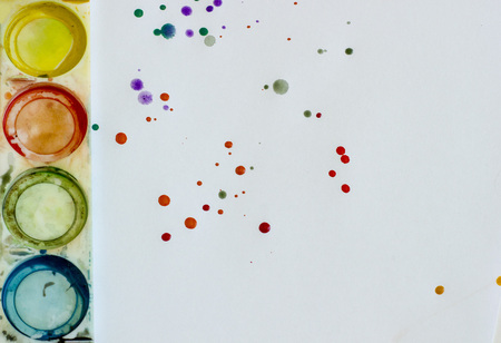 colored paint on a white sheet of paperの写真素材