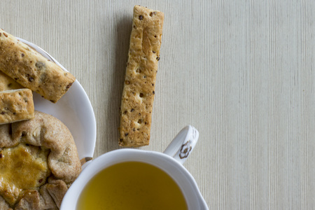a Cup of green tea with pastries on a saucerの写真素材