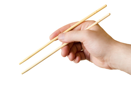 The image chopsticks in the man's hand isolatedの写真素材