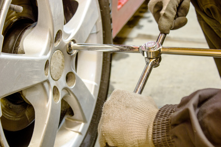 the image mechanic unscrews the wheel wrenchの写真素材