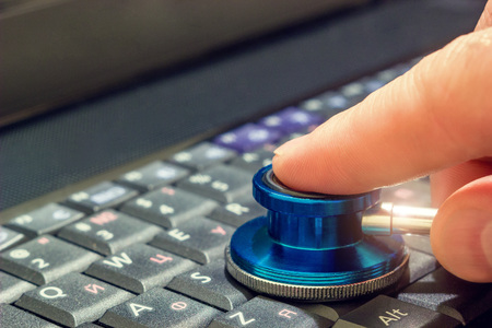 Stethoscope on the keyboardの写真素材