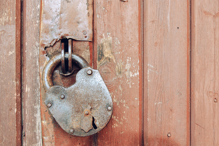 the image rusty padlock on old wooden doorの写真素材
