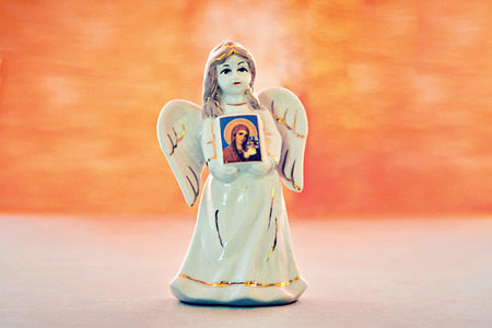 The figure of the angel in the background