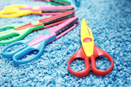 scissors for children paper on the background of the carpetの写真素材