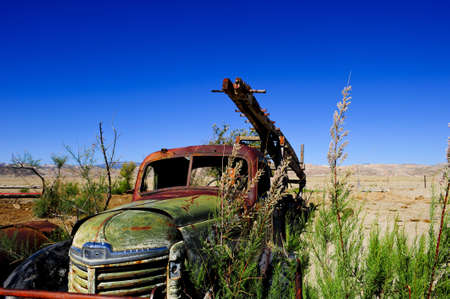 An abandoned water drilling rig sits rusting along the roadway in Cathedral Wash, Capital Reef National Parkの写真素材