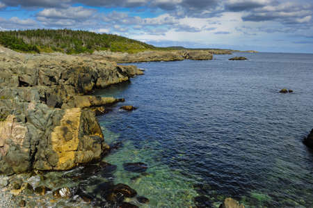 Rocky Shoreline with clear green and blue water.の写真素材