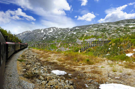 Train from skagway alaska to White Pass Alaska approaching a trestleの写真素材