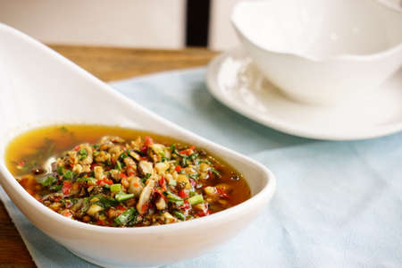 A bowl of dish on the tableの写真素材