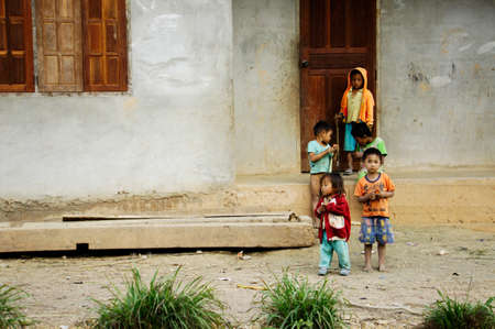 Children standing in front of houseのeditorial素材