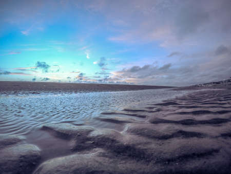 Beach with undulating sand and waterの写真素材