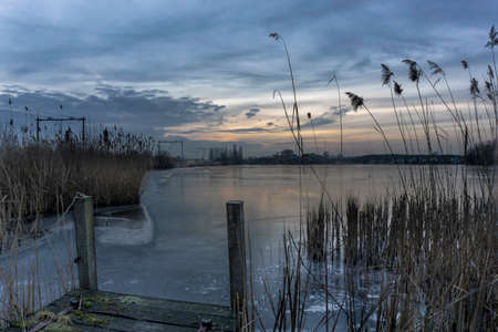 Frozen lake with pierの写真素材