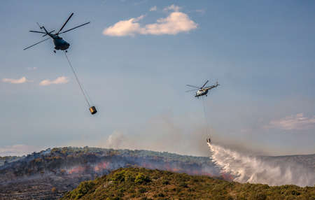 Helicopters extinguish forest fire in Croatiaの写真素材