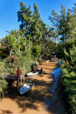 small boats docked on wooden scaffolding in Tigre Deltaの写真素材