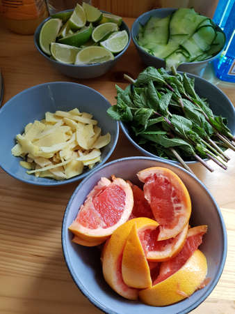 Bowl with cocktail ingredients on wooden backgroundの写真素材