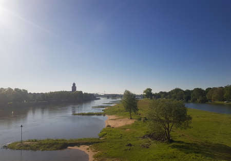 River IJssel and the skyline of Deventer in the Netherlandsの写真素材