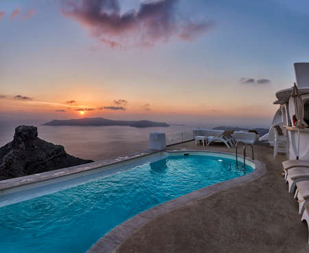 Beautiful sunset at infinity pool in Santoriniの写真素材