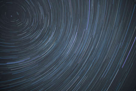 Astro photography time lapse or star trails rotating around the north polar star showing the rotation of eathの写真素材