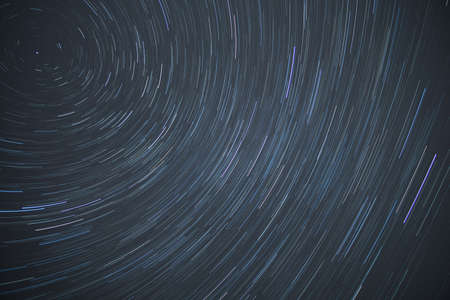 Astro photography time lapse or star trails rotating around the north polar star showing the rotation of eathの写真素材