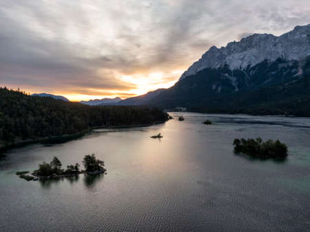 Aerial of the Eibsee lake and Zugspitze mountain in Bavaria, Germany at sunriseの写真素材