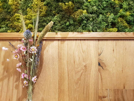 Wooden wall with flowers background with copy space on the right for wishing card conceptの写真素材