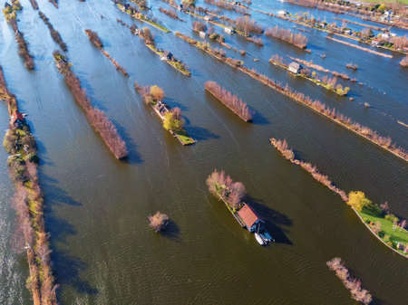 Aerial view of dutch houses built on very small islands surrounded by water in the Loosdrechtse plassen, living isolated in nature conceptの素材 [FY310144222857]