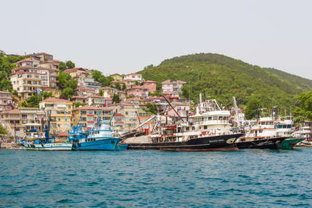 Istanbul Turkey 05.30.2013. Houses over water with ships and boats.のeditorial素材
