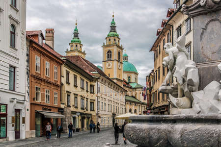 Ljubljana Slovenia September 1 2014. View from the Robba Fountain of an old street houses and the St. Nicholas39 Cathedral.のeditorial素材