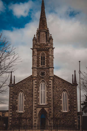 Traditional local Catholic Church against the blue sky and clouds.の写真素材