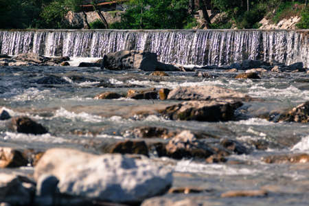 Threshold on the mountain river with boulders.の写真素材