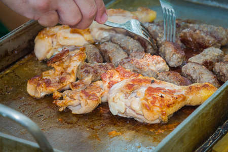The process of grilling chicken and kebab.