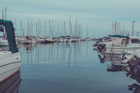 Small boats parked in docks in the morning mist.の写真素材