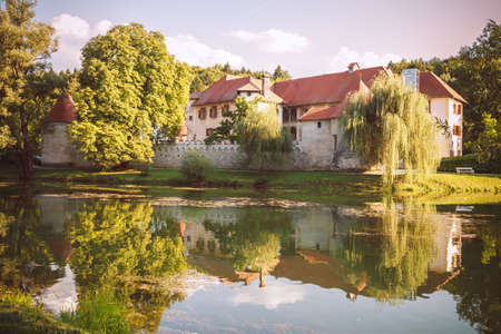 Otocec, Slovenia - September 12, 2015. Grad Otocec, castle and its reflection in the middle of the river Krka.のeditorial素材