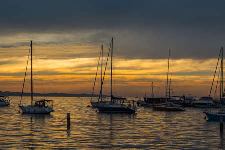 Sky and boats in the rays of the evening sun.の写真素材