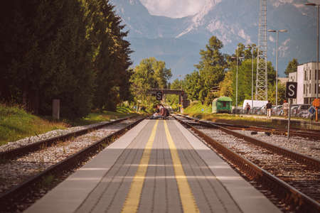 Railway going from a station to the massive mountains.の写真素材