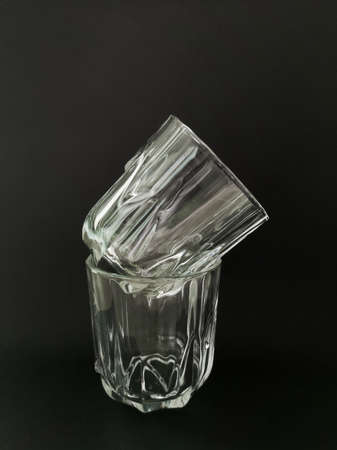 Two faceted empty glasses on a black backgroundの写真素材