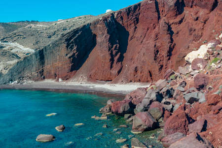 Red Cliffs and Turquoise Water of Santorinis Red Beachの写真素材