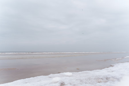 Baltic Sea coast on a winter cloudy day in Jurmala, Latviaの写真素材