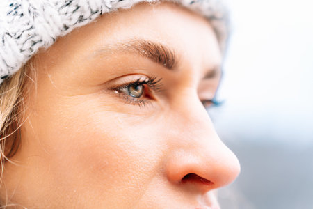 close-up of a womans face in winter showing her joyful expression.