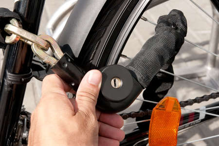 hand holding locked bike chain