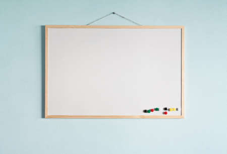 Message board hanging on a blue wall.の写真素材