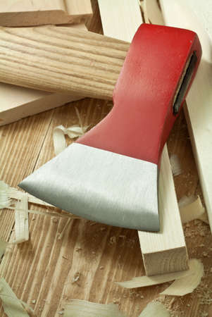 Wood workshop. Red ax over planks.の写真素材