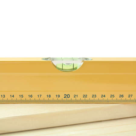 Yellow level tool on wood plank.