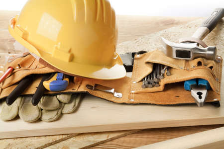 Yellow helmet and tool belt.