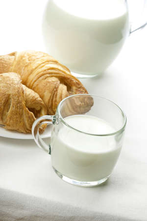 Breakfast table with milk and buns.の写真素材