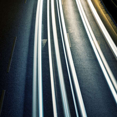 Night road with car lights traces.