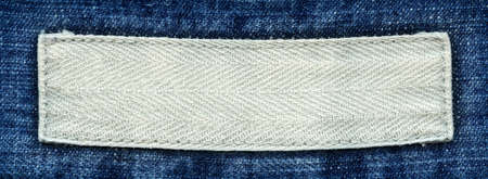 Blank textile label  sewed on a blue jeans  Can be used as background for your text 