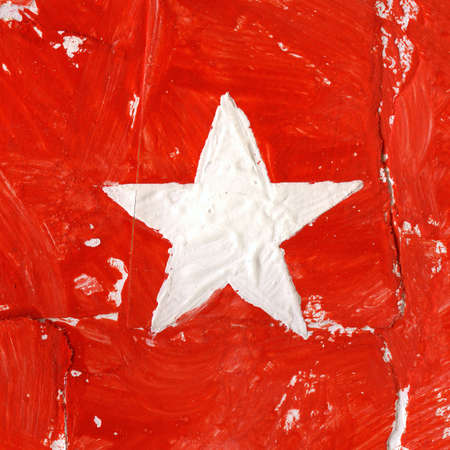 Painted acrylic white star on red の写真素材