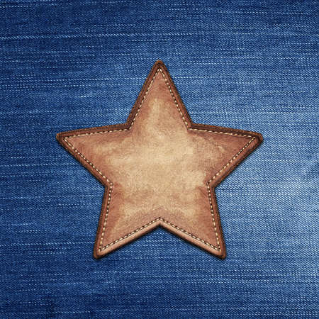 Star shape leather label on jeans textureの写真素材